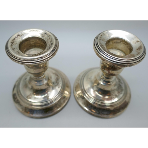 7337 - A pair of small silver candlesticks, London 1954, 7cm, 385g total (weighted bases)