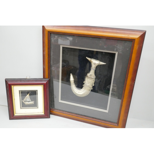 7343 - A framed white metal model of a ship, and a framed Arabic dagger, largest frame 37cm