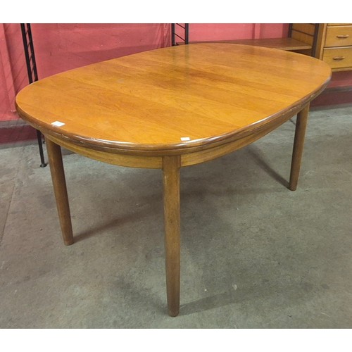 126 - A teak oval extending dining table and six chairs