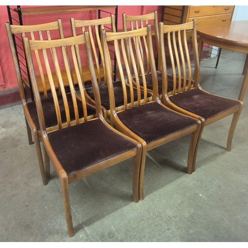 126 - A teak oval extending dining table and six chairs