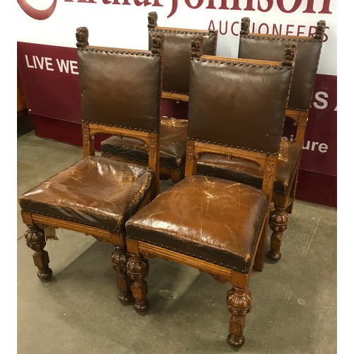 180 - A set of four Victorian Gothic Revival carved oak dining chairs