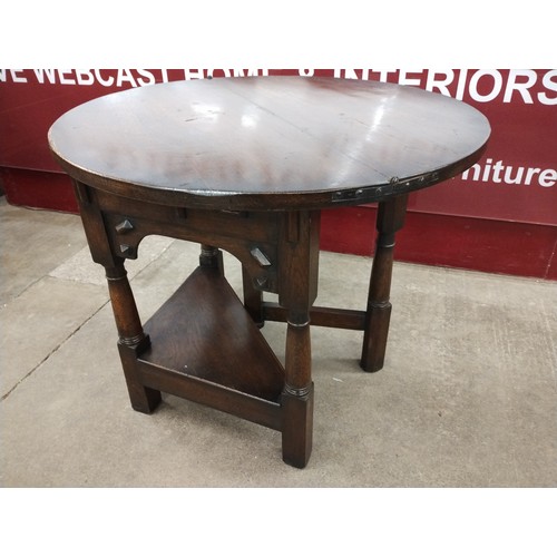 184 - A 17th Century style oak demi lune fold over tea table