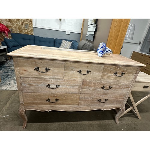 3070 - A bleached wood 7 drawer French style sideboard - (Damaged back board)