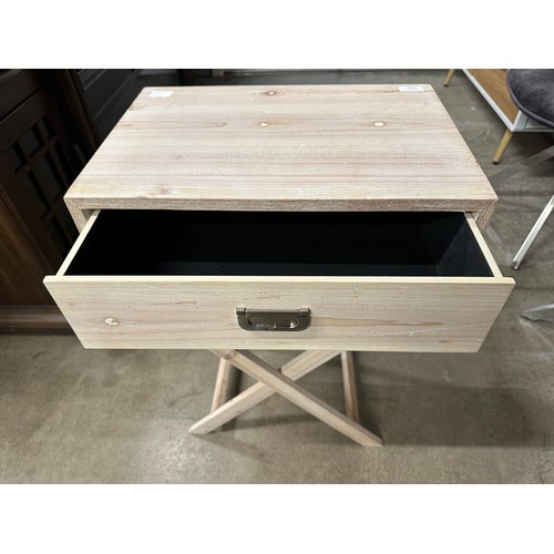 3071 - A bleached wood single drawer side table with crossed legs - (Legs require attention)