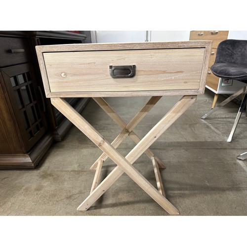 3071 - A bleached wood single drawer side table with crossed legs - (Legs require attention)