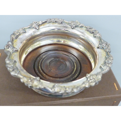 2028 - A Garrard silver plated wine coaster with vine detail, with a Garrard box