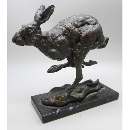 2038 - A bronze sculpture of a hare, signed Kinsella, height 12.5cm