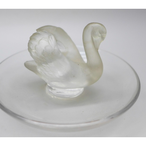 2043 - Two small Lalique glass dishes, swan and ram detail, signed to base