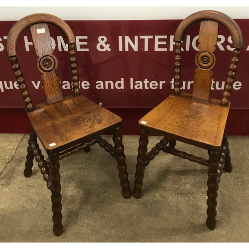 161 - A pair of Arts and Crafts oak hall chairs