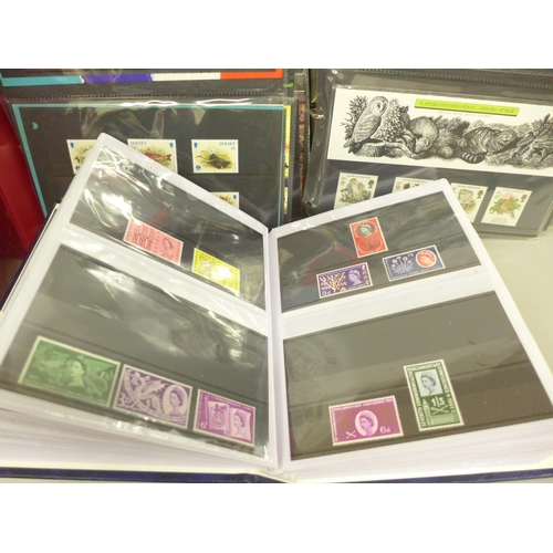 2060 - Stamps; a collection of stamps in three albums, including fifty mint stamps, twelve Millennium stamp... 