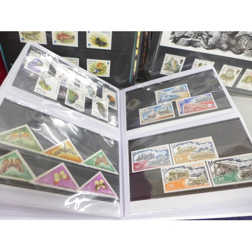 2060 - Stamps; a collection of stamps in three albums, including fifty mint stamps, twelve Millennium stamp... 