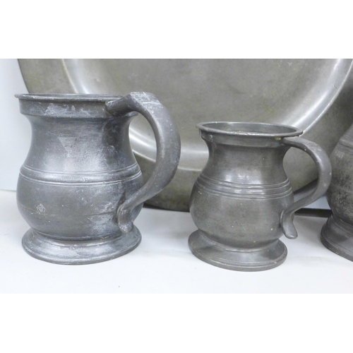 2073 - Two pewter plates and five pewter measures, the largest marked James Yates