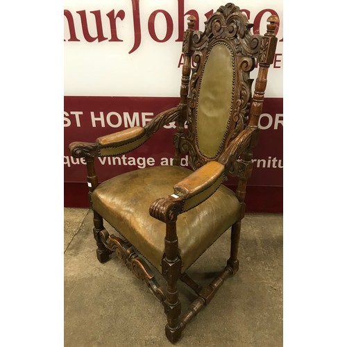 163 - An early 20th Century Carolean Revival carved oak and green leather throne chair