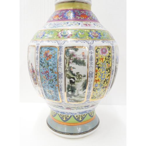 2180 - A large Chinese famille rose temple vase with panelled oriental scenes and gilt twin handles. With s... 