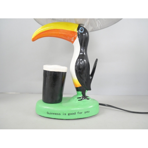 2194 - A fibreglass Guinness advertising toucan table lamp with shade. Reads 