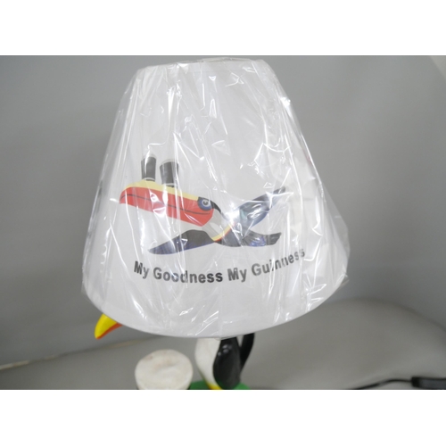 2194 - A fibreglass Guinness advertising toucan table lamp with shade. Reads 