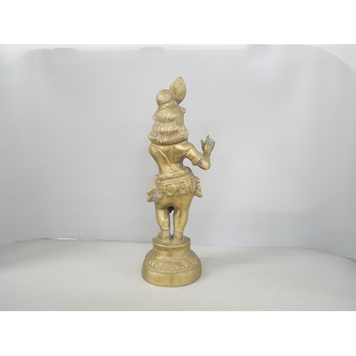 2199 - An Indian gilt metal figure of Krishna on circular base.