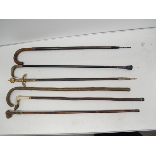 2265 - Five assorted walking canes and a reproduction sword *This lot is not available for packing and post... 