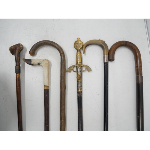 2265 - Five assorted walking canes and a reproduction sword *This lot is not available for packing and post... 