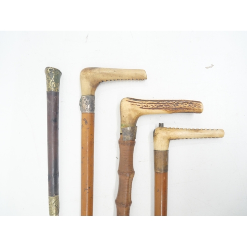 2270 - A collection of walking canes and a horse whip, one with fox detail