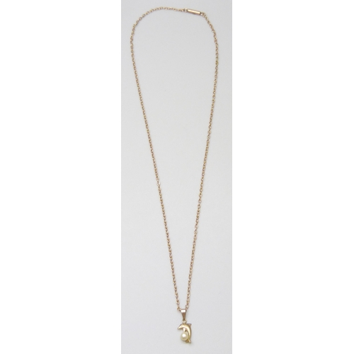 7002 - A 9ct gold chain together with a 9ct gold dolphin pendant set with a pearl, 2.4g, pendant 1.5cm, cha... 