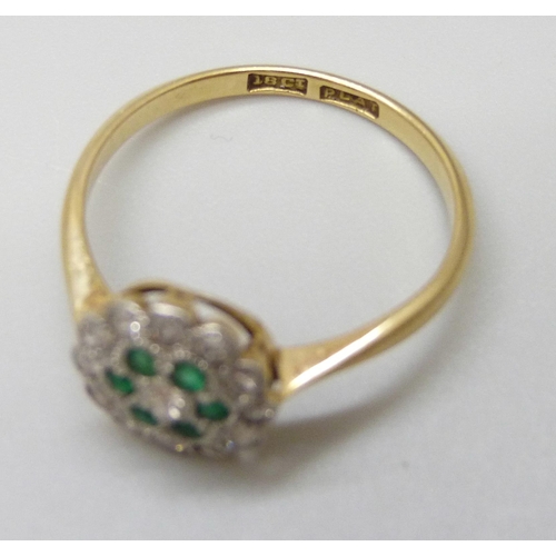 7009 - An 18ct gold and platinum set emerald and diamond cluster ring, circa 1920s, 2.2g, N