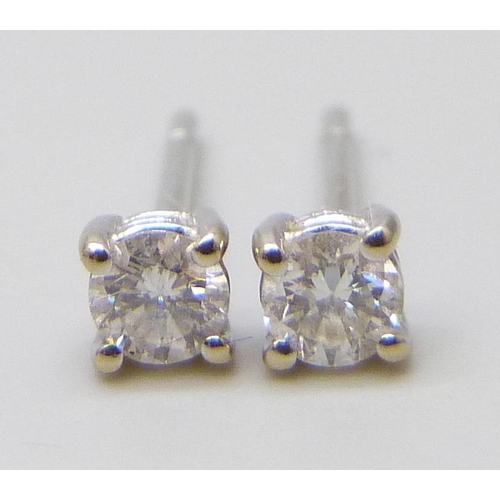 7010 - A pair of 18ct white gold diamond stud earrings, 0.9g