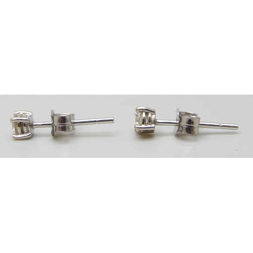 7010 - A pair of 18ct white gold diamond stud earrings, 0.9g