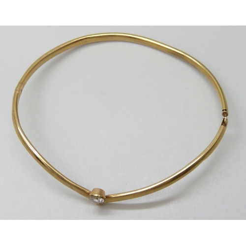 7023 - A 9ct gold bangle set with a white paste stone, 3.1g, a/f