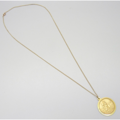 7026 - A 9ct gold St Christopher pendant, 3.3cm including bale, on a 9ct gold chain, 6.8g total