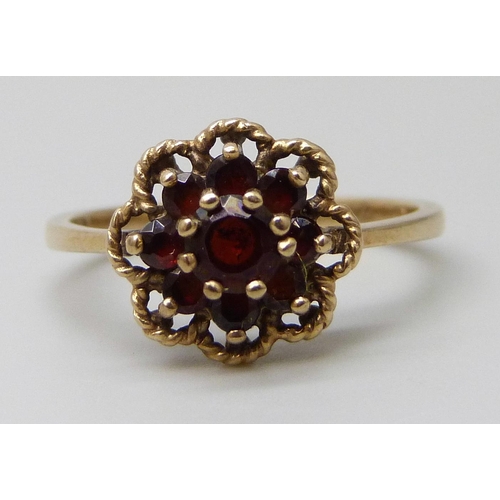 7028 - Two 9ct gold garnet set cluster rings, one central stone a/f, 4.3g total