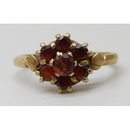 7028 - Two 9ct gold garnet set cluster rings, one central stone a/f, 4.3g total