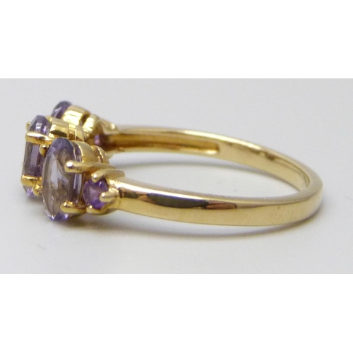 7039 - A 9ct gold ring set with amethysts, 2.3g, N