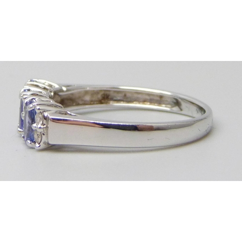 7041 - A 9ct white gold ring set with 0.59ct of tanzanite and 0.12ct of diamonds, 2.1g, N