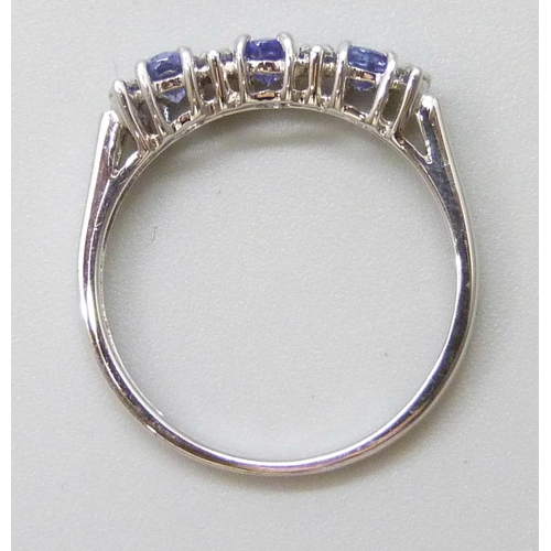 7041 - A 9ct white gold ring set with 0.59ct of tanzanite and 0.12ct of diamonds, 2.1g, N