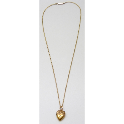 7065 - A 15ct gold pendant set with a diamond, inscription verso, 1.1g, on a 9ct gold chain, 2.1g, some lin... 