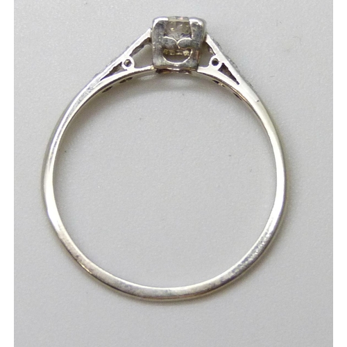 7067 - A white metal diamond set ring, approximately 0.2 carat main stone, indecipherable marks, 1.7g, P/Q