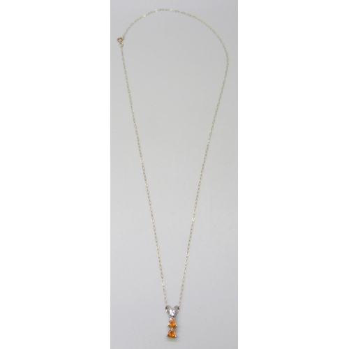 7081 - A white metal set orange stone and diamond pendant, on a 9ct gold chain, 1.5cm, 1.1g