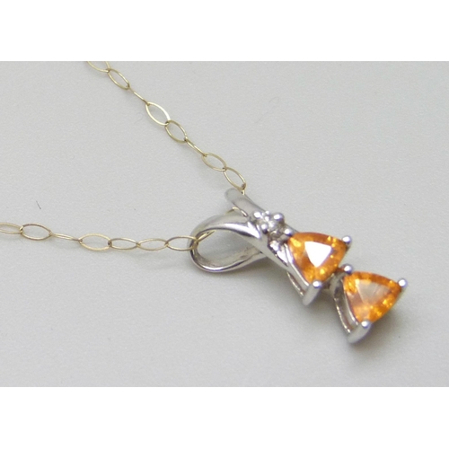 7081 - A white metal set orange stone and diamond pendant, on a 9ct gold chain, 1.5cm, 1.1g