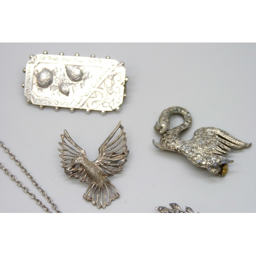 7128 - A white metal enamelled locket, a Victorian silver brooch, 3.8cm, and three other brooches