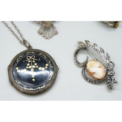 7128 - A white metal enamelled locket, a Victorian silver brooch, 3.8cm, and three other brooches