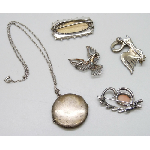 7128 - A white metal enamelled locket, a Victorian silver brooch, 3.8cm, and three other brooches