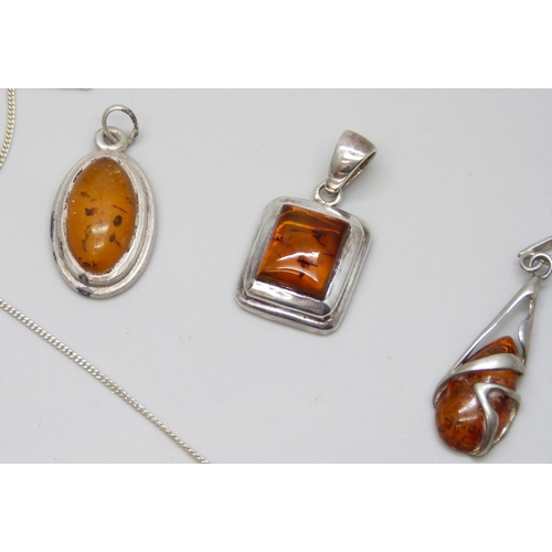 7130 - Five silver and amber pendants, one on a silver chain, 19g total weight