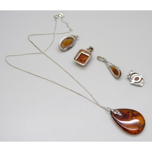 7130 - Five silver and amber pendants, one on a silver chain, 19g total weight