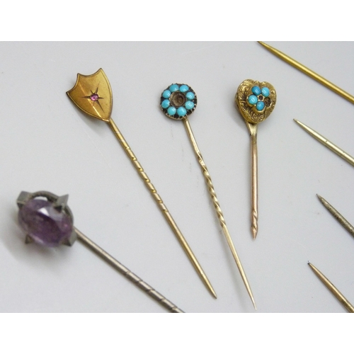 7139 - A collection of Victorian and later gilt stick pins and white metal examples