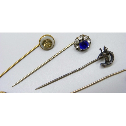 7139 - A collection of Victorian and later gilt stick pins and white metal examples