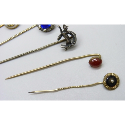 7139 - A collection of Victorian and later gilt stick pins and white metal examples