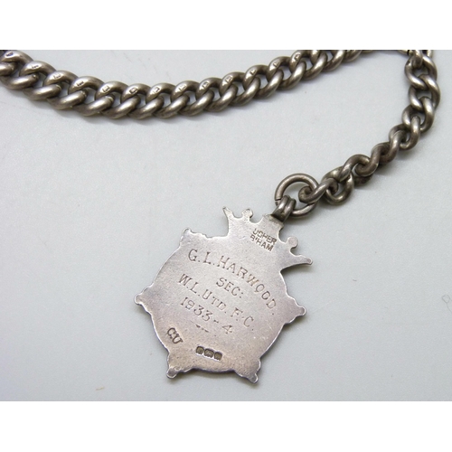 7153 - A silver Albert chain and silver fob, 59g, 35cm