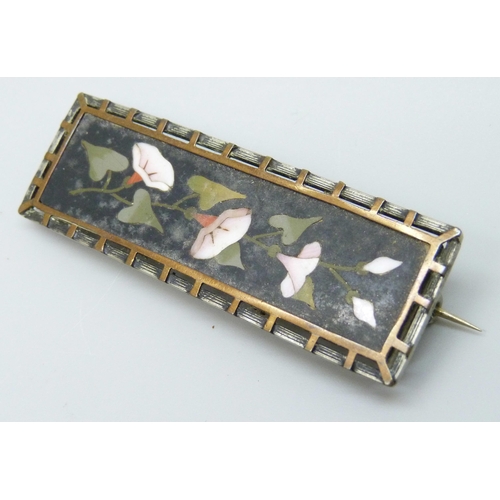 7177 - A pietra dura brooch in a metal mount, 6.3cm