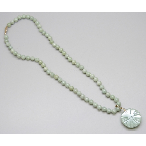 7179 - A green stone necklace, tests as jadeite, 14k clasp and bale, 35g, 44cm